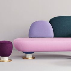 three different colored couches sitting next to each other