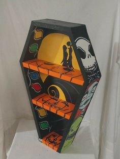 an artistically painted hexagonal object with skeleton figures on the sides and orange shelves