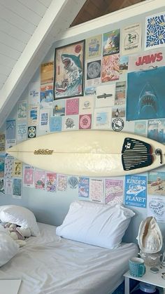 a surfboard mounted to the side of a wall above a bed in a bedroom