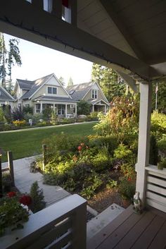 the back porch is full of flowers and plants