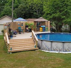 an above ground swimming pool with steps leading up to it and a deck in the background