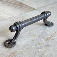 an old metal handle on a marble surface