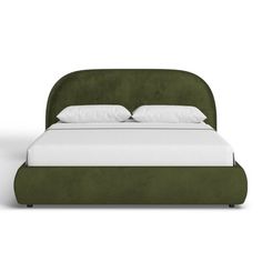 a green bed with white pillows on it