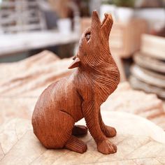 a small wooden animal sitting on top of a table