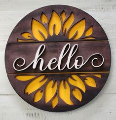 a wooden sign with the word hello painted on it's side and yellow flowers