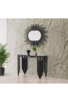 a black console table sitting next to a wall with a mirror on top of it