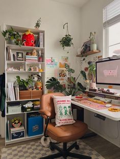 a home office with plants on the shelves and a computer desk in front of it