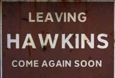 a close up of a street sign with the words leaving hawkins come again soon