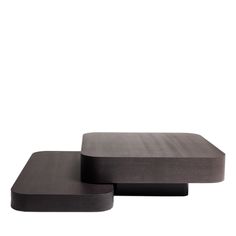 two black square tables sitting next to each other on top of a white surface with no one in it