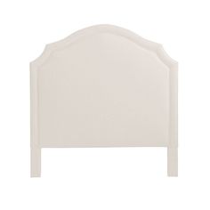 a white headboard with an arched design