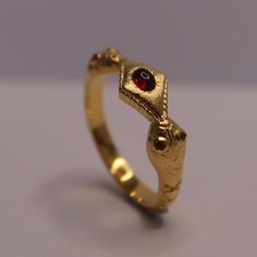 Adjustable sizing by opening and closing the head of the snake.  The red color of rubies symbolizes good fortune and protection, making the snake ring with ruby eyes a popular choice. Ensuring that every glance of the piece fills them with strength and power Chunky Gold Rings, Snake Ring Gold, Gold Ring For Women, Red Snake, Jewellery Design Sketches, Bold Rings, Snake Ring, 18k Gold Ring, Jewellery Design