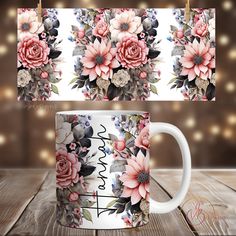 two coffee mugs with flowers on them sitting on a wooden table next to string lights