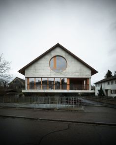 a white house with a large round window