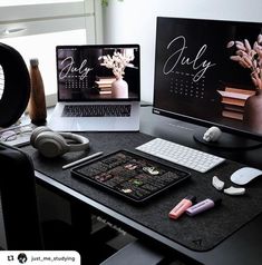 two laptops are sitting on a desk with headphones and other items in front of them