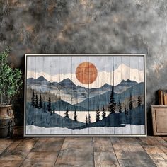 a painting on the wall with mountains and trees