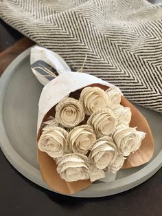 a plate with some flowers on it and a cloth bag in the backround