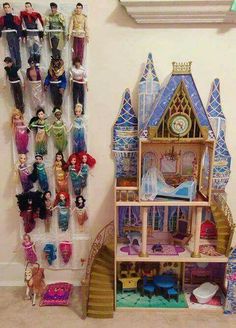 an image of a doll house with barbie dolls on the shelves and toys hanging from the wall