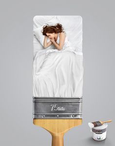 a woman laying in bed on top of a table