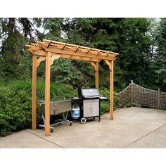 an outdoor grill and bbq in the middle of a yard