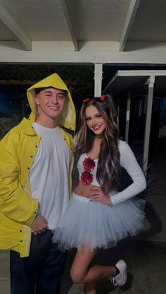 two people dressed in costumes standing next to each other