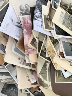 a pile of old photographs sitting next to each other