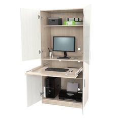 a computer desk with a monitor, keyboard and mouse on it's shelf in front of a white wall