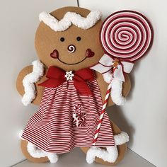 a gingerbread man holding a giant candy lollipop