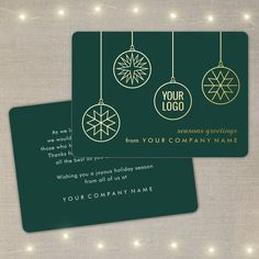 two business cards with christmas ornaments hanging from strings on the front and back of them