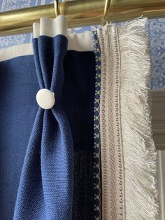 two blue and white towels hanging from a metal rod