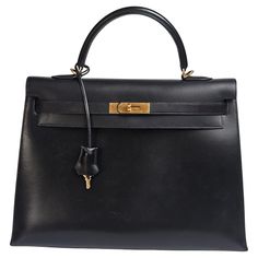 Rare vintage Hermes kelly 35 bag in black box leather with gold hardware. Beautiful condition overall, with minor scuffing on the body leather due to the nature of the leather. Overall still in very good vintage condition. Stamp square D (2000). Comes with its strap, tools and vintage dust bag. Slight tarnishing on the hardware and padlock and keys. Black Hermes Kelly Bag, Hermes Kelly Bag, Vintage Hermes, Kelly Bag, Hermes Bag, Black Box, Vintage Box, Vintage Bags, Luxury Vintage