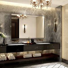 a fancy bathroom with two sinks and a chandelier hanging from the ceiling above it