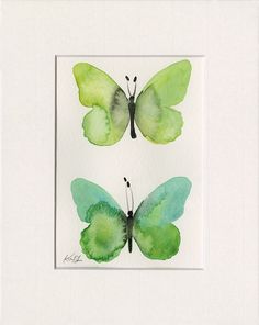 two watercolor paintings of green butterflies on white paper, one with black and blue wings