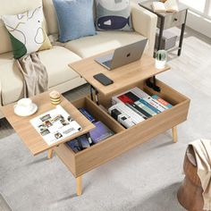 a living room with a couch, coffee table and laptop