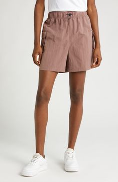 These high-waisted shorts are made from a soft, smooth woven fabric with a roomy fit, making them perfect for workouts and casual wear. Cargo pockets allow for secure storage of your small essentials. 4 1/2" inseam; 28" leg opening; 13" front rise; 17" back rise (size Medium) Drawcord-toggle waist 100% nylon Machine wash, tumble dry Imported Nike Shorts With Built-in Shorts, Nike Athleisure Athletic Shorts For Summer, Nike Summer Athleisure Athletic Shorts, Athleisure Shorts With Elastic Waistband In Recycled Polyester, Relaxed Fit Activewear With Short Inseam, Stretch Shorts With Elastic Waistband In Recycled Polyester, Stretch Recycled Polyester Shorts With Elastic Waistband, Nike Bottoms With Elastic Waistband, Short Length, Nike Athleisure Shorts For Summer