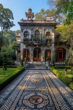 an elaborately designed walkway leads to the front entrance of a large, ornate home