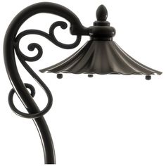 a black lamp with an ornate design on it's side and a white background