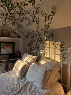 the morning sun is shining a golden light on a white bed with decoration vines on the ceiling Vines Above Bed On Ceiling, White Bedroom With Vines, Bedroom With Vines, Vine Ceiling Bedroom Aesthetic, Bed Frame Bedroom Vines, Bedroom Vines, Vines Bedroom, Vine Leaves Room Decor Aesthetic, Curtains Around Bed