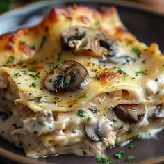 a close up of a plate of food with cheese and mushrooms on it's surface