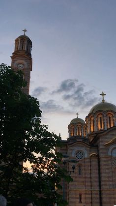 an old church with two towers at sunset