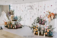 wedding dress and flowers on display in front of curtained backdrop at the grand hyate