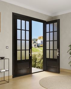 a living room with two doors open and a potted plant in the corner next to it