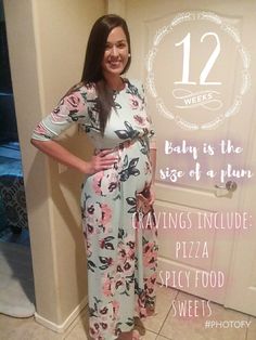 a pregnant woman standing in front of a door