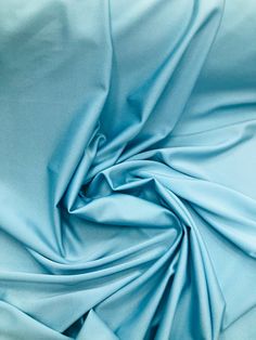 a close up view of a light blue fabric