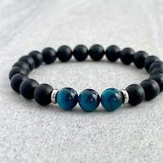 Men's beaded bracelet made with strong, stretchy cord and genuine/natural gemstones. Features ~ 6mm, 8mm or 10mm matte onyx beads ~ 6mm, 8mm or 10mm yellow tiger eye beads ~ 4mm, 6mm or 8mm stainless steel spacers (can be worn in the water and will not tarnish) ~ Stretchy cord; simply slide bracelet on and off wrist ~ Comes packaged in a re-usable micro fibre pouch To ensure the perfect fit, please use the bracelet sizing instructions found in the photo gallery. Onyx - A powerful protection stone, Black Onyx absorbs and transforms negative energy, and helps to prevent the drain of personal energy. Black Onyx aids the development of emotional and physical strength and stamina, especially when support is needed during times of stress, confusion or grief. Tiger Eye - A stone of protection, Ti Arm Band, Onyx, 10 Things