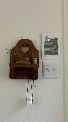 a wooden clock mounted to the side of a wall