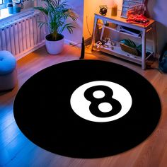 a black and white round rug with the number eight on it in a living room