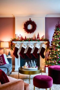 a living room decorated for christmas with stockings on the fireplace