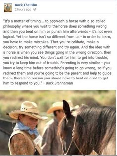 a man in cowboy hat standing next to a horse with another man on horseback behind him