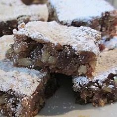 several pieces of brownie with powdered sugar on top