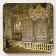 an ornately decorated bedroom with gold and white decor